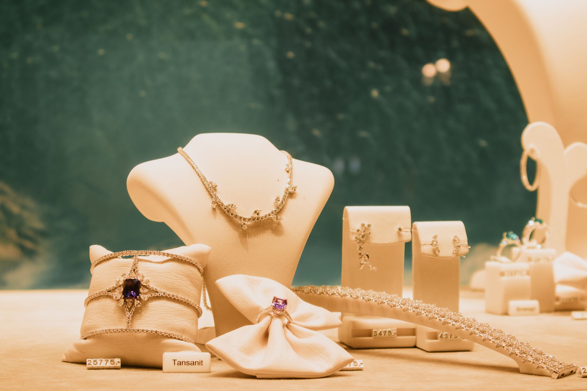 Necklaces, earrings, and a bracelet on display stands