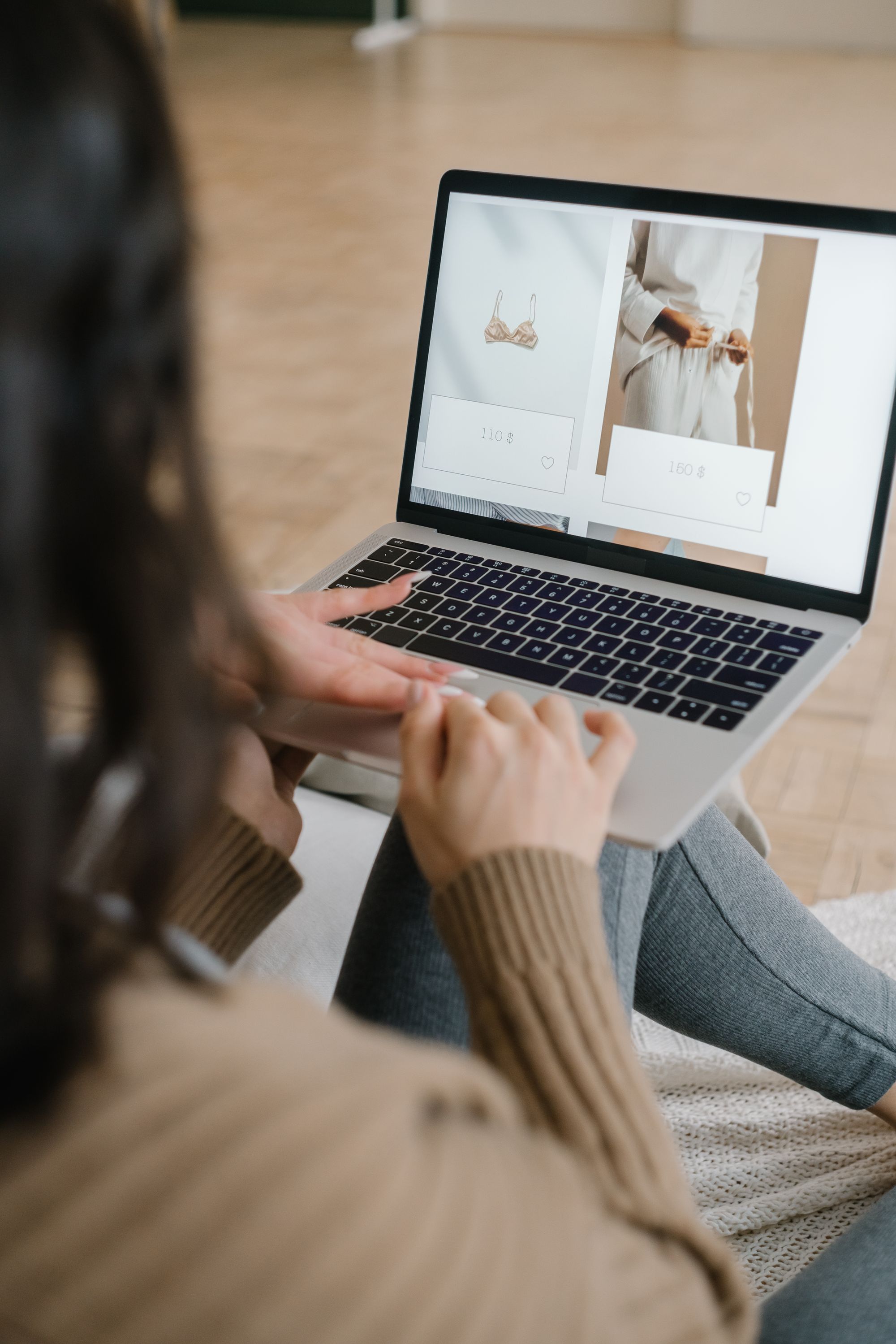 A laptop showing clothing on a product page
